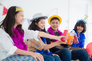 Group of Happy Asian teenager drinking soda with friends in Party.