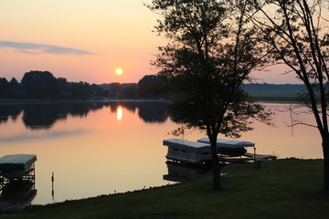 boat lift on lake at sunset