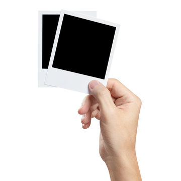 Hand holding blank photocards, isolated on white background