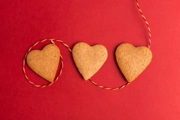 Fototapeta premium red background with heart cookie, valentines day