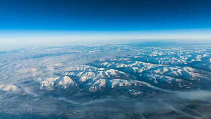 Aerial shot of snow caps from a plane
