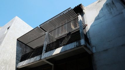 details of a modern loft construction of houses and clean blue sky, contrast of buildings.