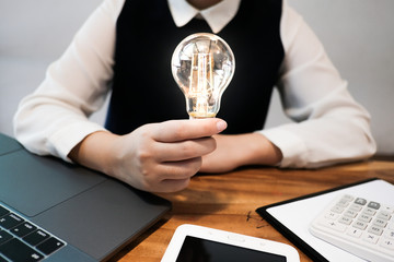 Creative idea Business women holding light bulbs Concept of idea technology and creativity