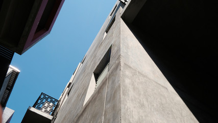 details of a modern loft construction of houses and clean blue sky, contrast of buildings.