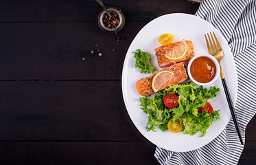 Baked salmon fillet with fresh vegetables salad. Healthy food. Ketogenic/paleo diet. Top view, copy space