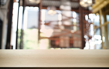 Empty dark wooden table in front of abstract blurred bokeh background of restaurant . can be used for display or montage your products.Mock up for space.