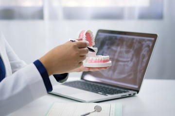 Dentist examining a patient teeth medical treatment at the dental office