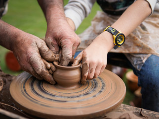 hands on potter creating a jar on circle