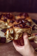 Brioche with chocolate in hand close-up