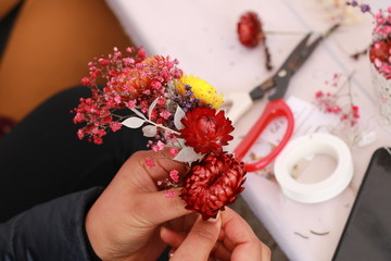 group arts and crafts activity making a natural colorful flower decoration using multi colored spring time flowers