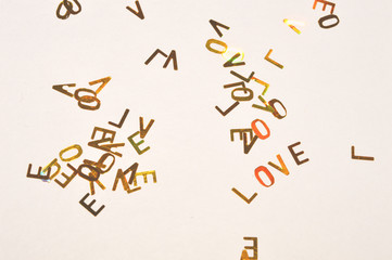 Background with gold glittering letters LOVE in vintage colors