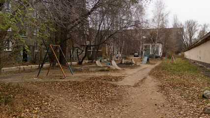 Fototapeta na wymiar Children's Playground empty. Soviet architecture.Old residential area.