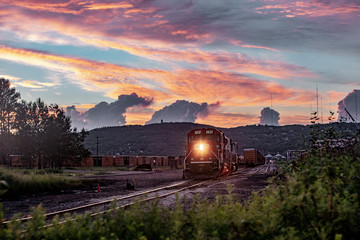 Fototapeta na wymiar sunset over the city with a train