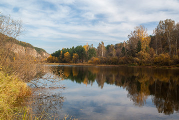 Picturesque autumn forest on the bay. Siberia
