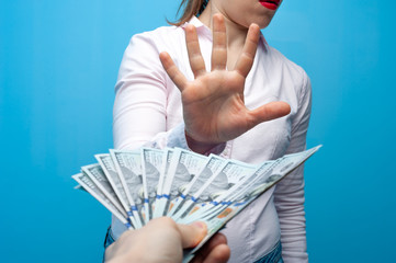 Woman raised her hand refusing a bribe