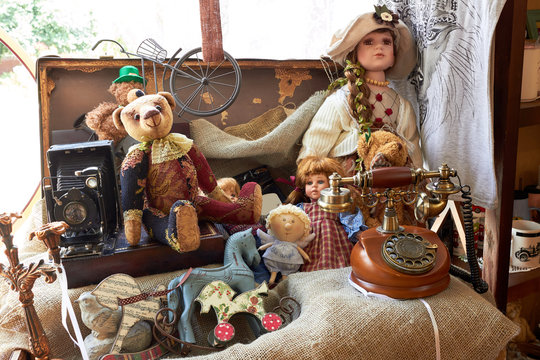 Suitcase With Toys And Dolls (Teddy Bear) And A Vintage Telephone. Vintage Style