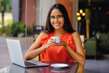Latinamerican girl have a coffee break in a cafe