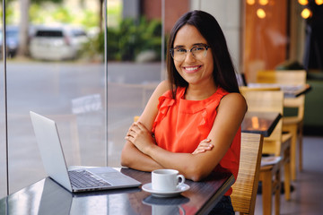 Latinamerican girl have a coffee break in a cafe