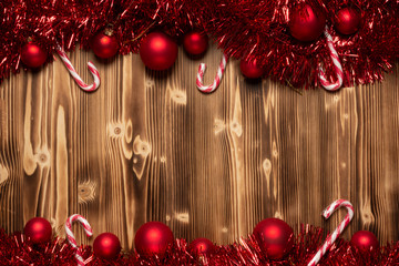 Christmas and new year background with red balls, sugar canes, red tinsel with copy space 