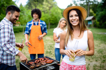 Small group of friends having fun at barbecue party