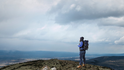 Fototapeta premium Hiker man in mountains. Mixed media
