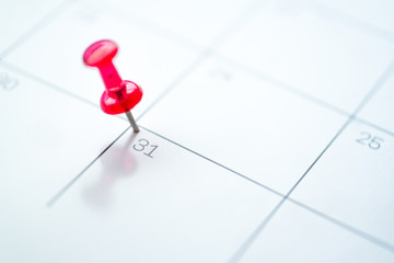 Red push pin on calendar 31st of the month, new year eve