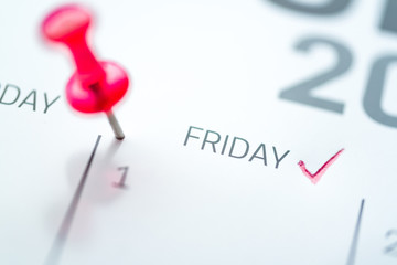 Red push pin on calendar 1st of the month