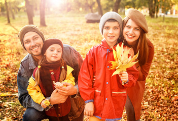 Happy family resting in autumn park