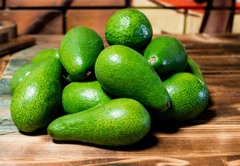 isolated avocado on a dark wood and white background. selective focus