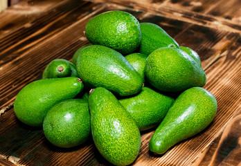 isolated avocado on a dark wood and white background. selective focus