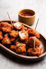 Mushroom 65, starter or appetiser food recipe from India. served in a plate with ketchup. selective focus