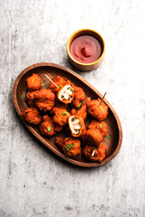 Mushroom 65, starter or appetiser food recipe from India. served in a plate with ketchup. selective focus