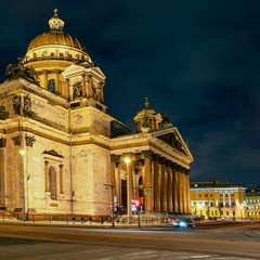 Fototapeta na wymiar facade of St. Isaac's Cathedral in the rays of light against the night sky in St. Petersburg, Russia