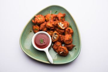 Mushroom 65, starter or appetiser food recipe from India. served in a plate with ketchup. selective focus