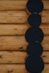 Wooden logs of natural color. The ends of the logs are treated with black.  Background and texture. 