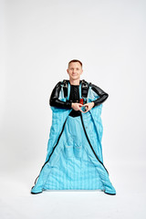 Heart by hands. Men in wing suit shows heart by hands. Skydiving men in parashute. Simulator of free fall.