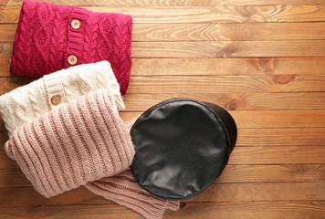 Warm clothes on wooden background