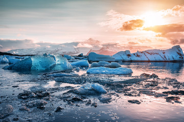 floating icebergs in Jokulsarlon glacier lagoon at sunset