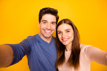 Obraz premium Close up photo of two students affectionate bonding spouses travel journey make selfie wear blue pink sweater isolated over bright shine color background