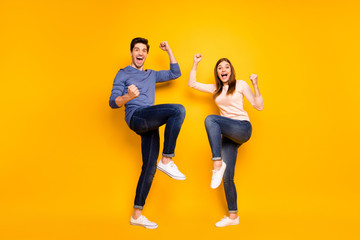 Fototapeta na wymiar Full size photo of ecstatic married spouses hear wonderful lottery win news raise fists scream yeah wear pink blue sweater sneakers isolated over shine color background