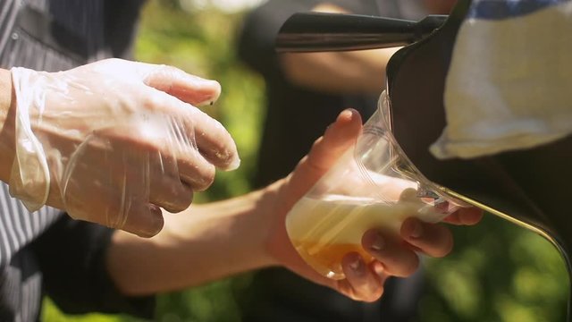 Waiter serving draft beer at a garden party
