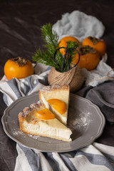 slices of persimmon cheesecake on beautiful plates. dark background. 