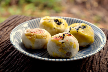 Moon Cak in a beautiful ceramic dish style. Very tasty. Laid on the floor of an old wooden table
