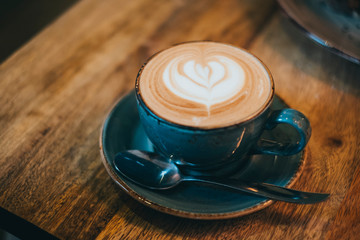 Closeup of cappuccino on wooden table in cafe