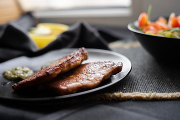 fried meat with vegetable salad and pesto. 