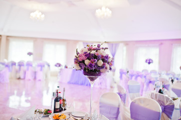 Beautiful wedding purple set decoration in the restaurant.