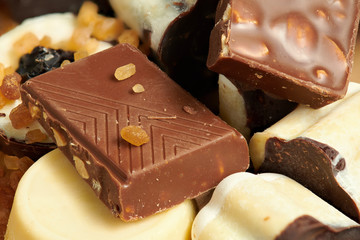 Chocolate bars and homemade candies on rustic table, sweet food, macro photo