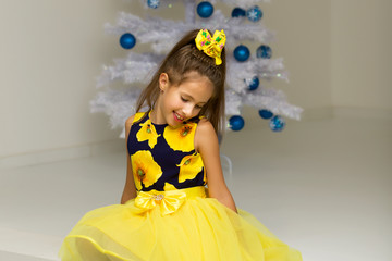 The girl at the Christmas tree.Beautiful little girl near the Ch