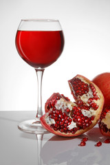 Ripe pomegranate and a glass with pomegranate juice