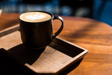 cup of coffee on wooden table